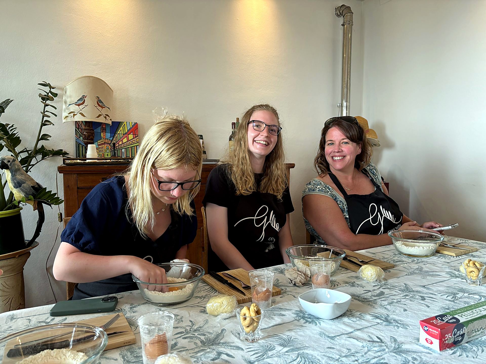 Students making fresh pasta during a cooking class in Tuscany