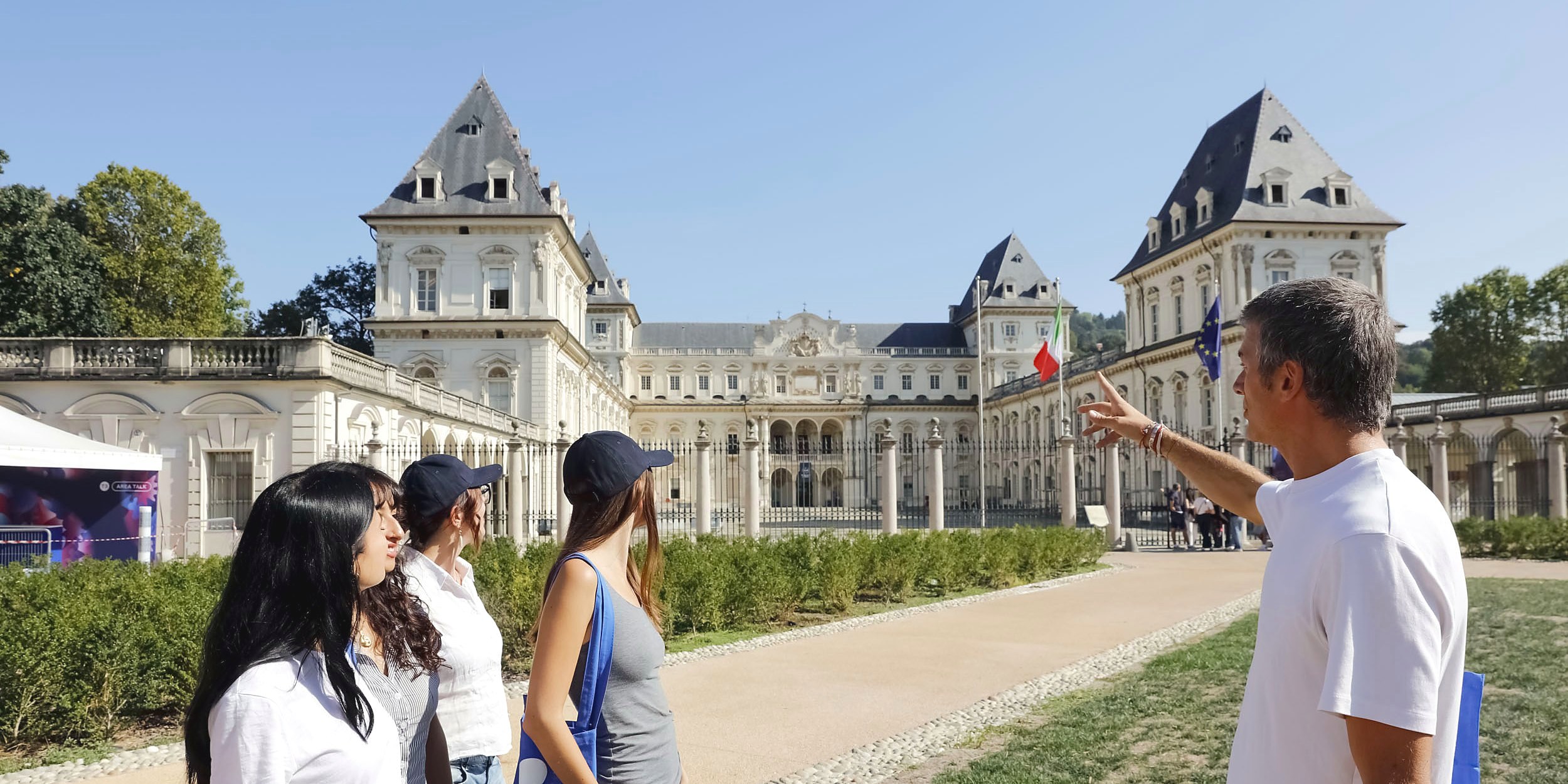 A lecturer leading students on a site visit to the Valentino Castle in Turin