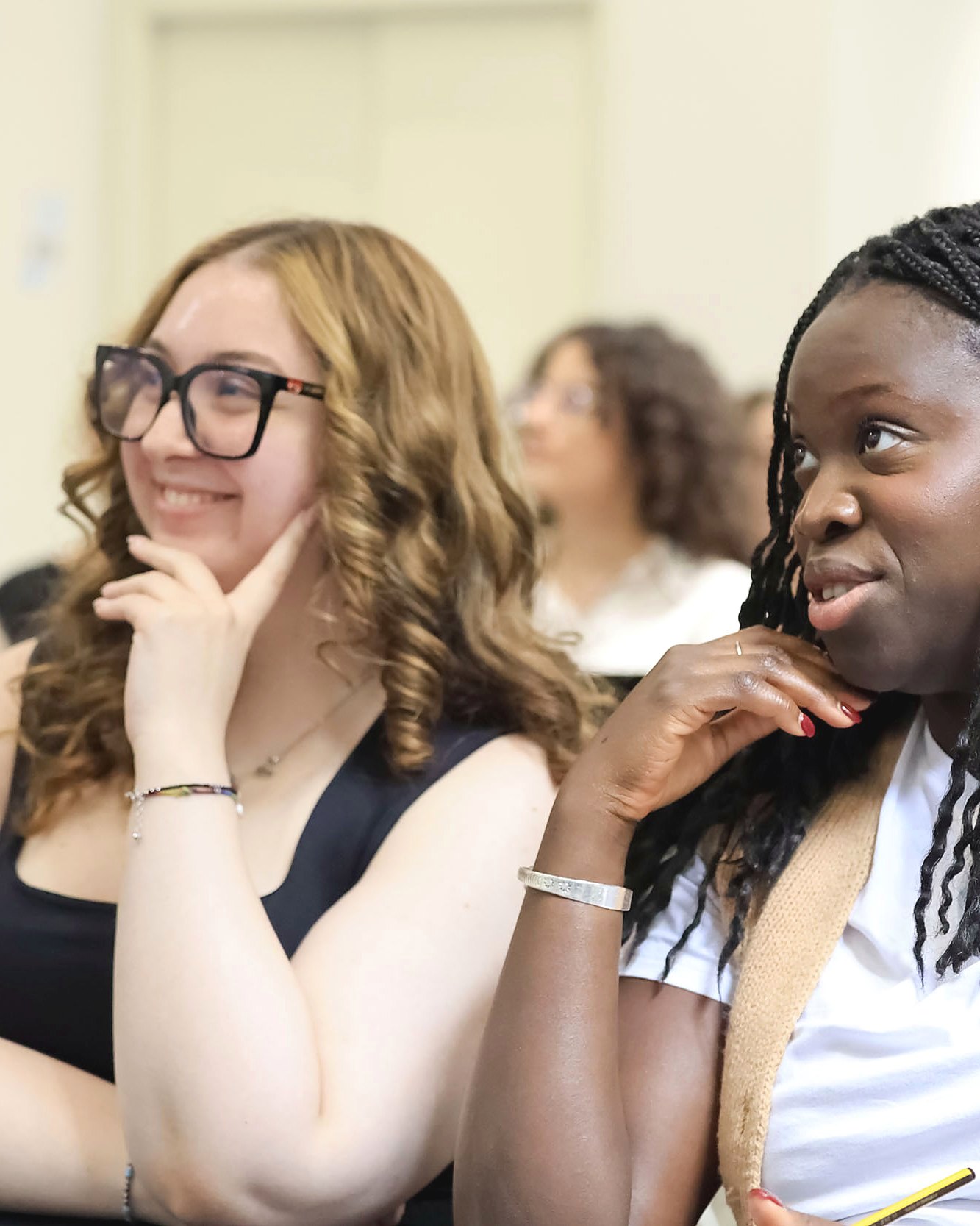 Two students smiling during a class taught in English