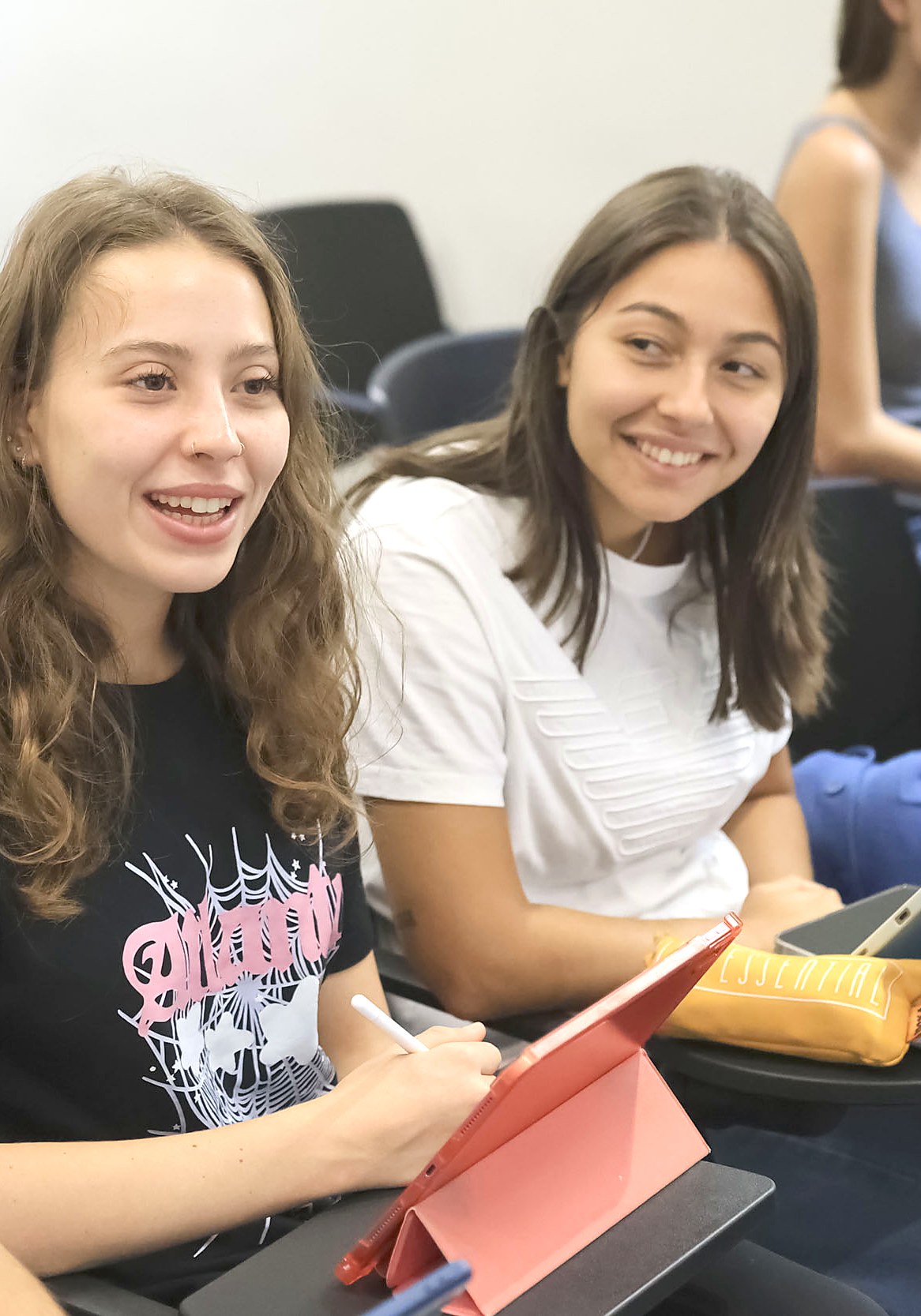 Two students laughing together during a class at Unicollege