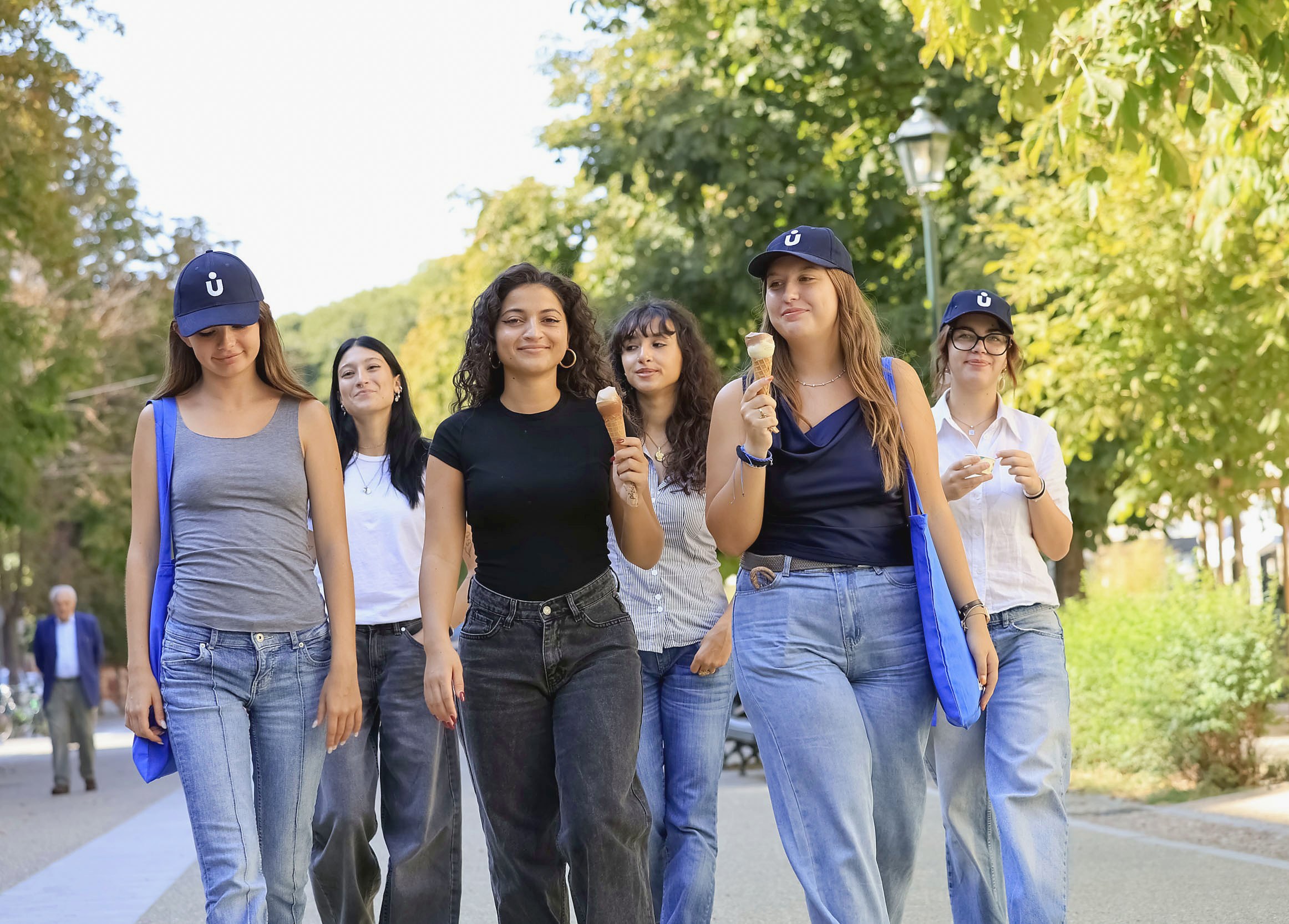 Young students walking together along a tree-lined avenue in Turin