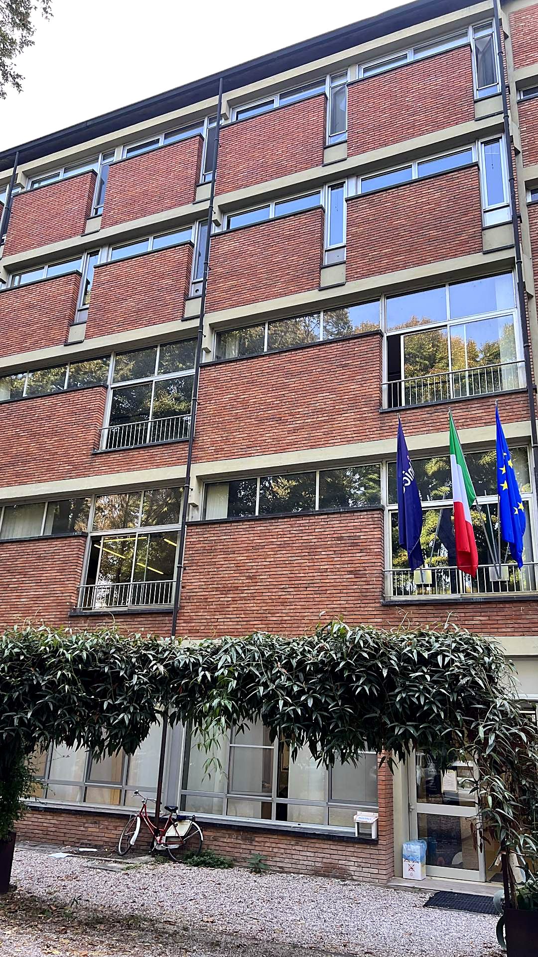 The Unicollege building in Mantua, with the Italian and European flags