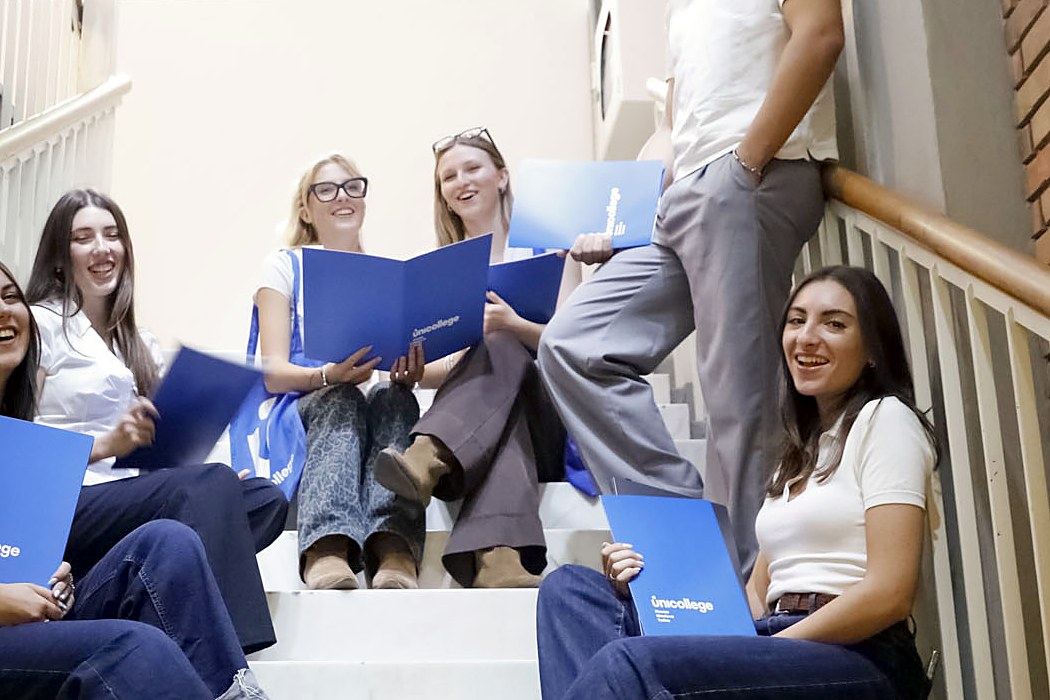 Students sitting together on the main staircase of the Mantua campus