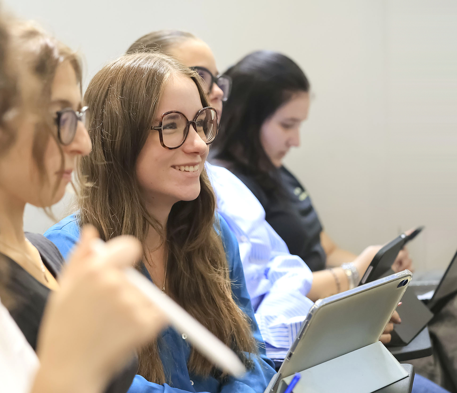 A pre-college student smiling during a class at the Unicollege campus in Turin