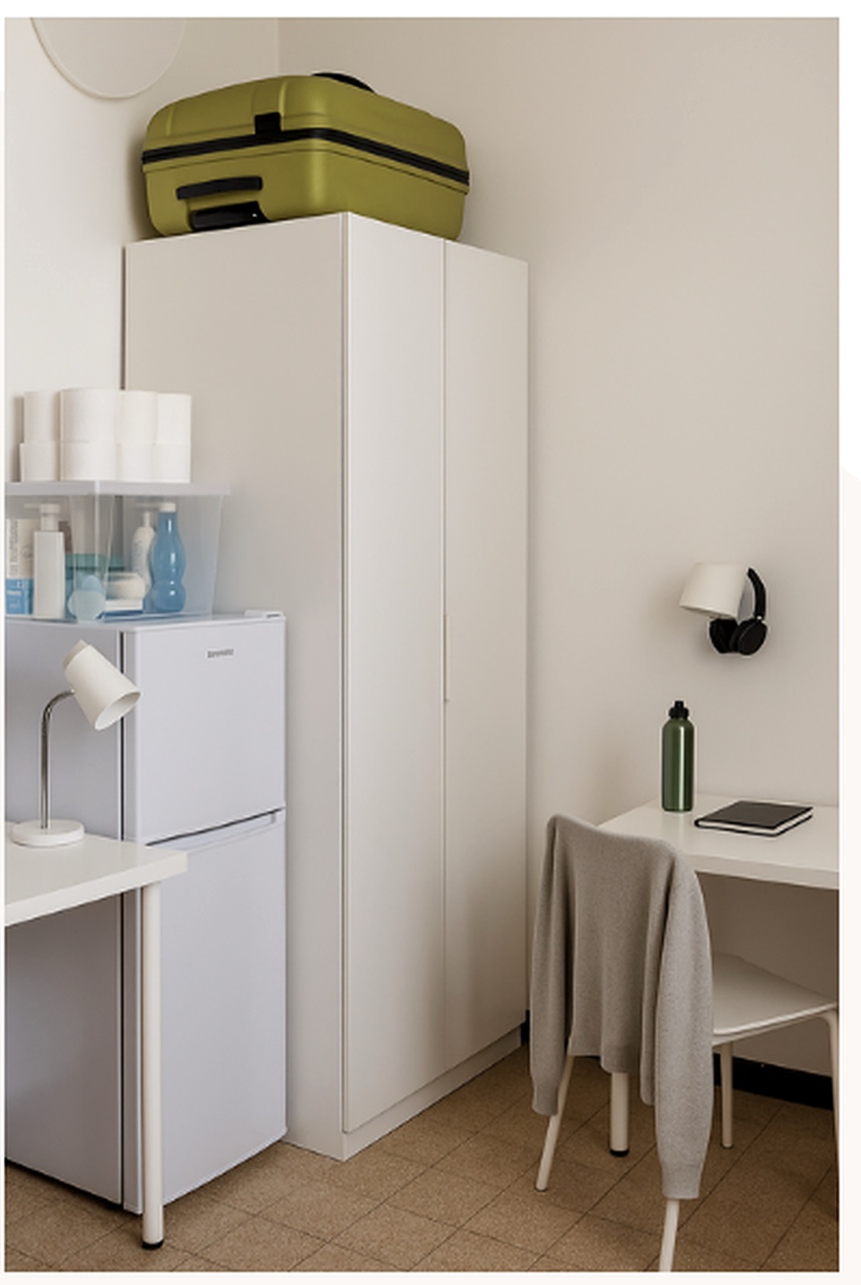 A residence room corner with desk, fridge and storage