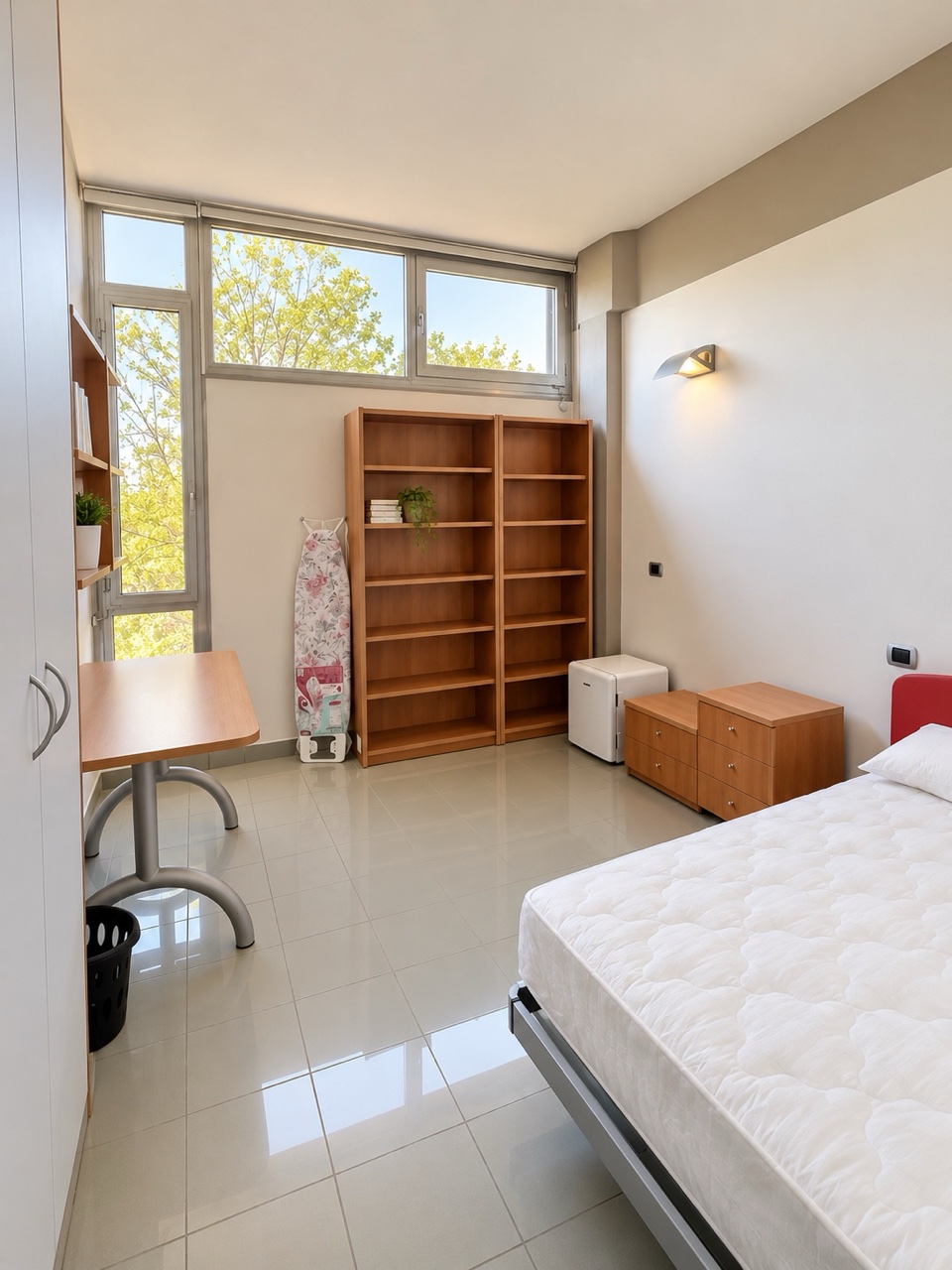 A single residence room with bookshelf and study chair