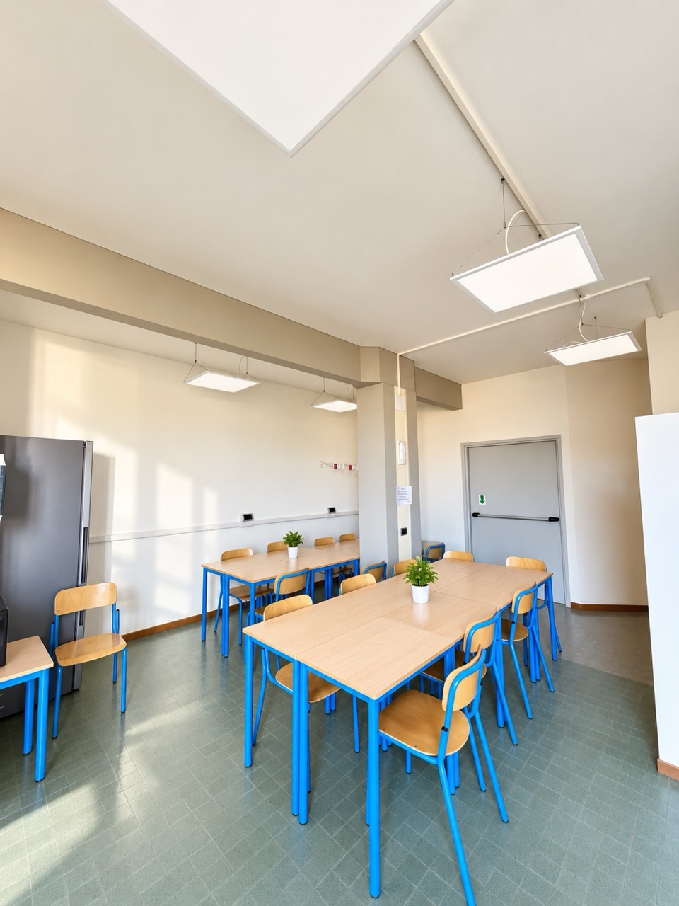 A residence study room with blue tables and chairs
