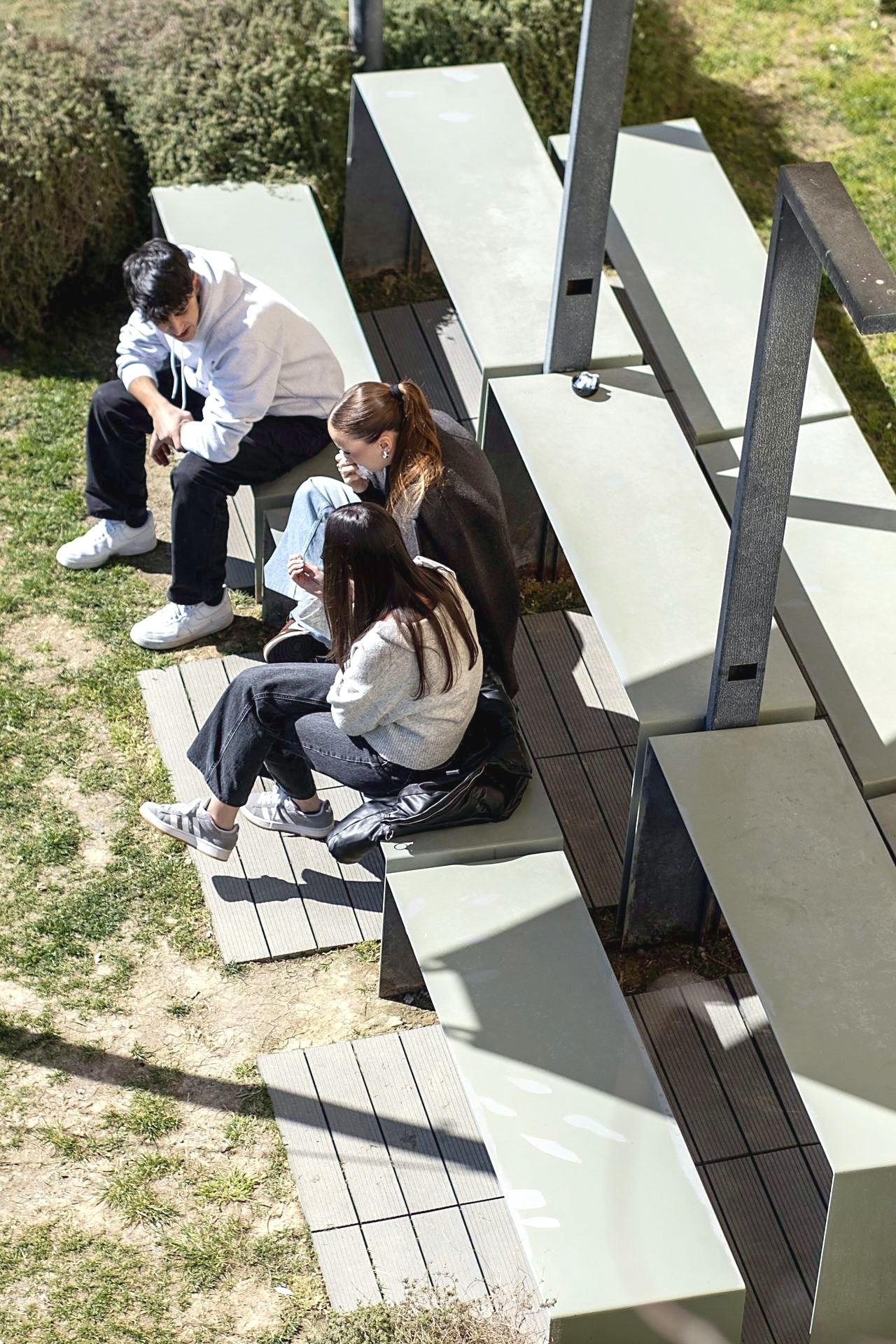 Students sitting on the benches in the campus grounds