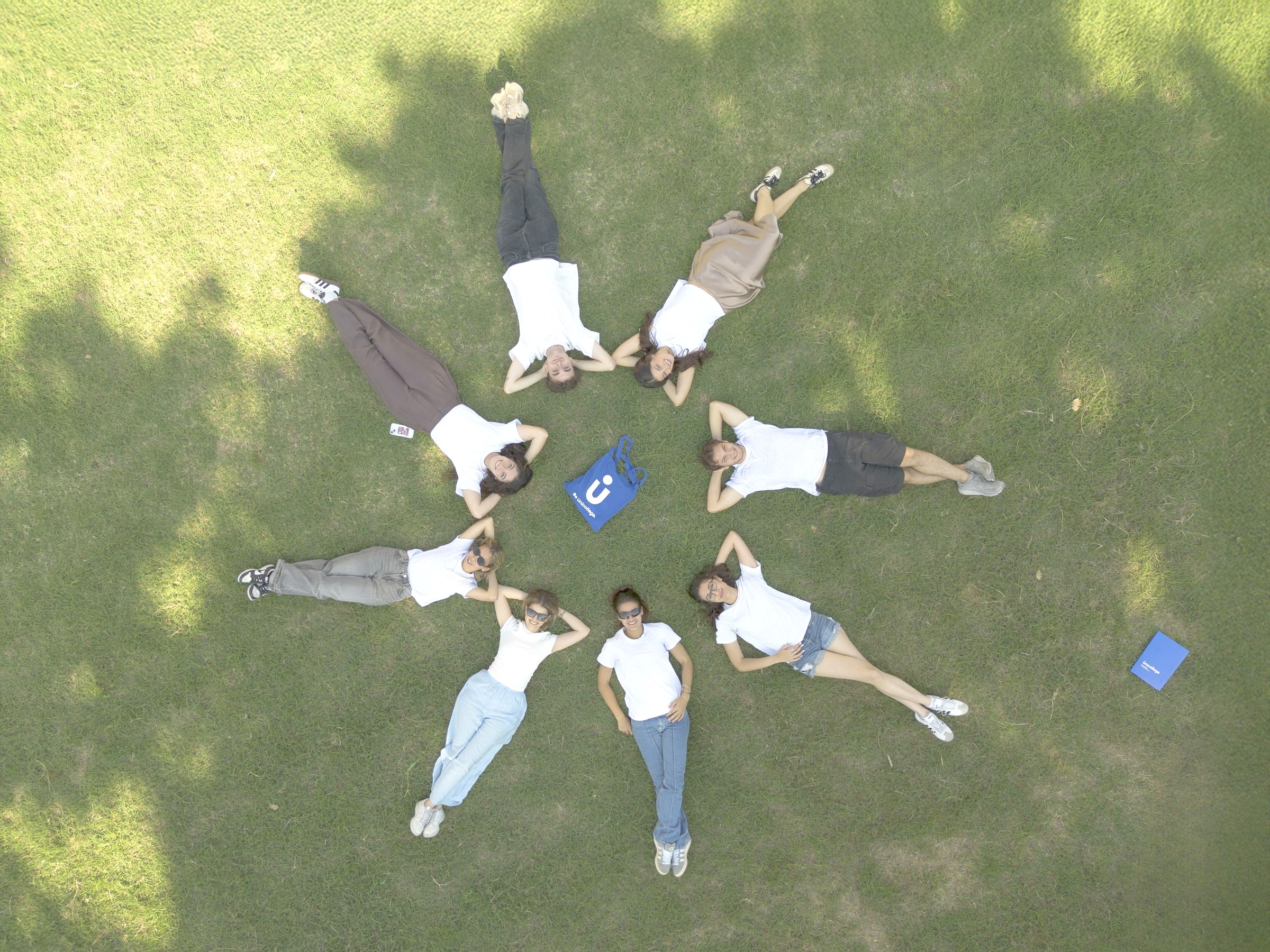 Students lying in a circle on the lawn of the Florence campus
