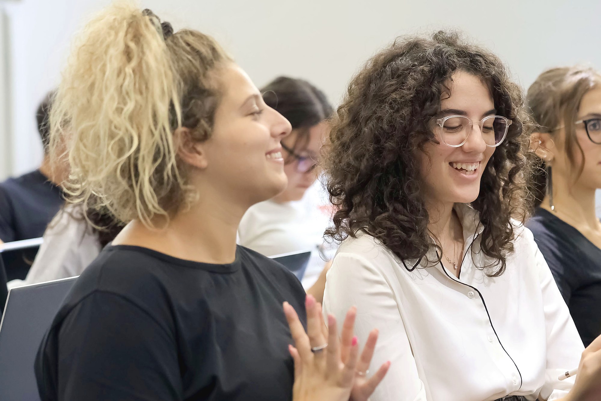 Students laughing together during a class on the Turin campus