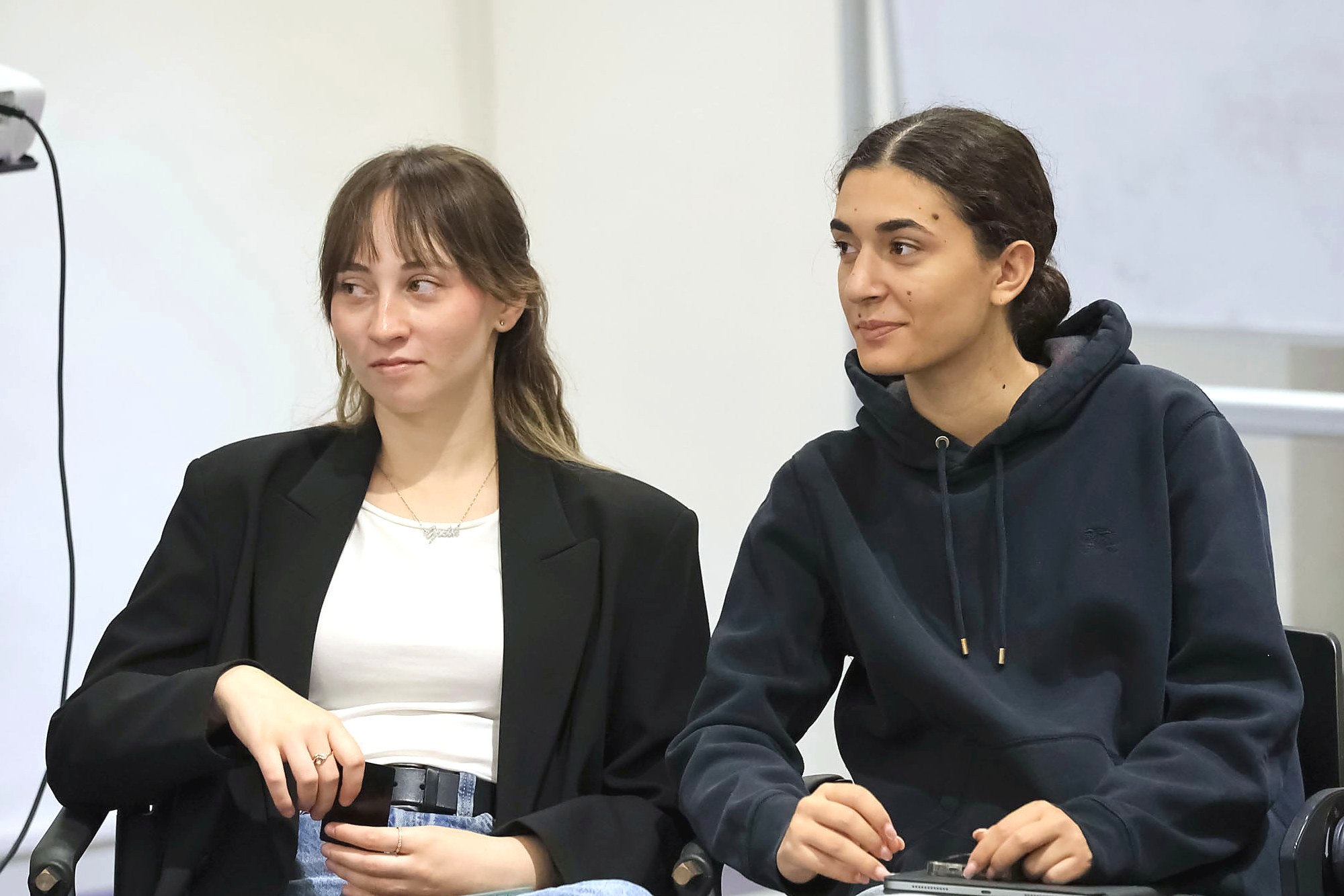 Two students smiling during a class on the Turin campus
