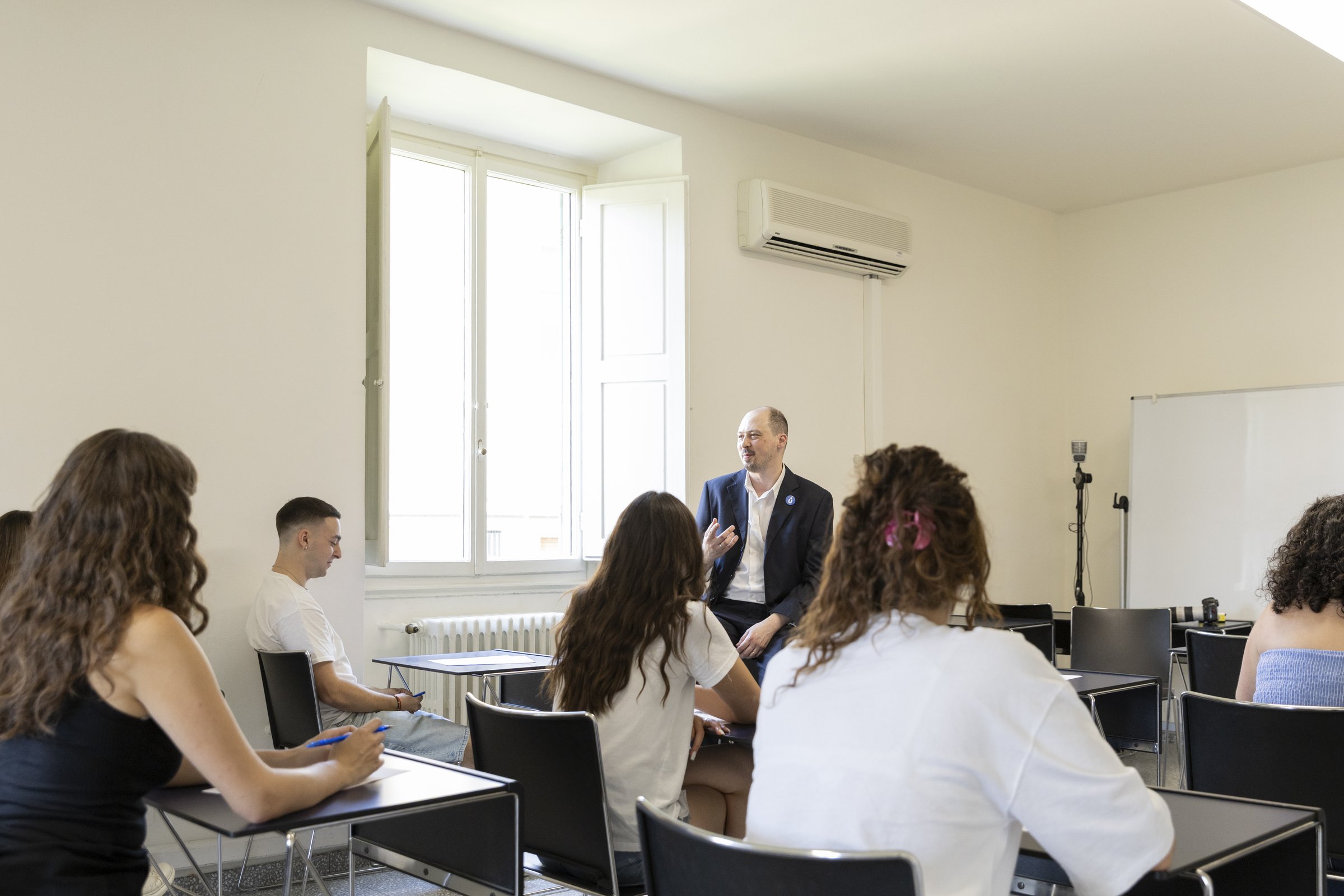 A professor in conversation with students during a seminar at Unicollege