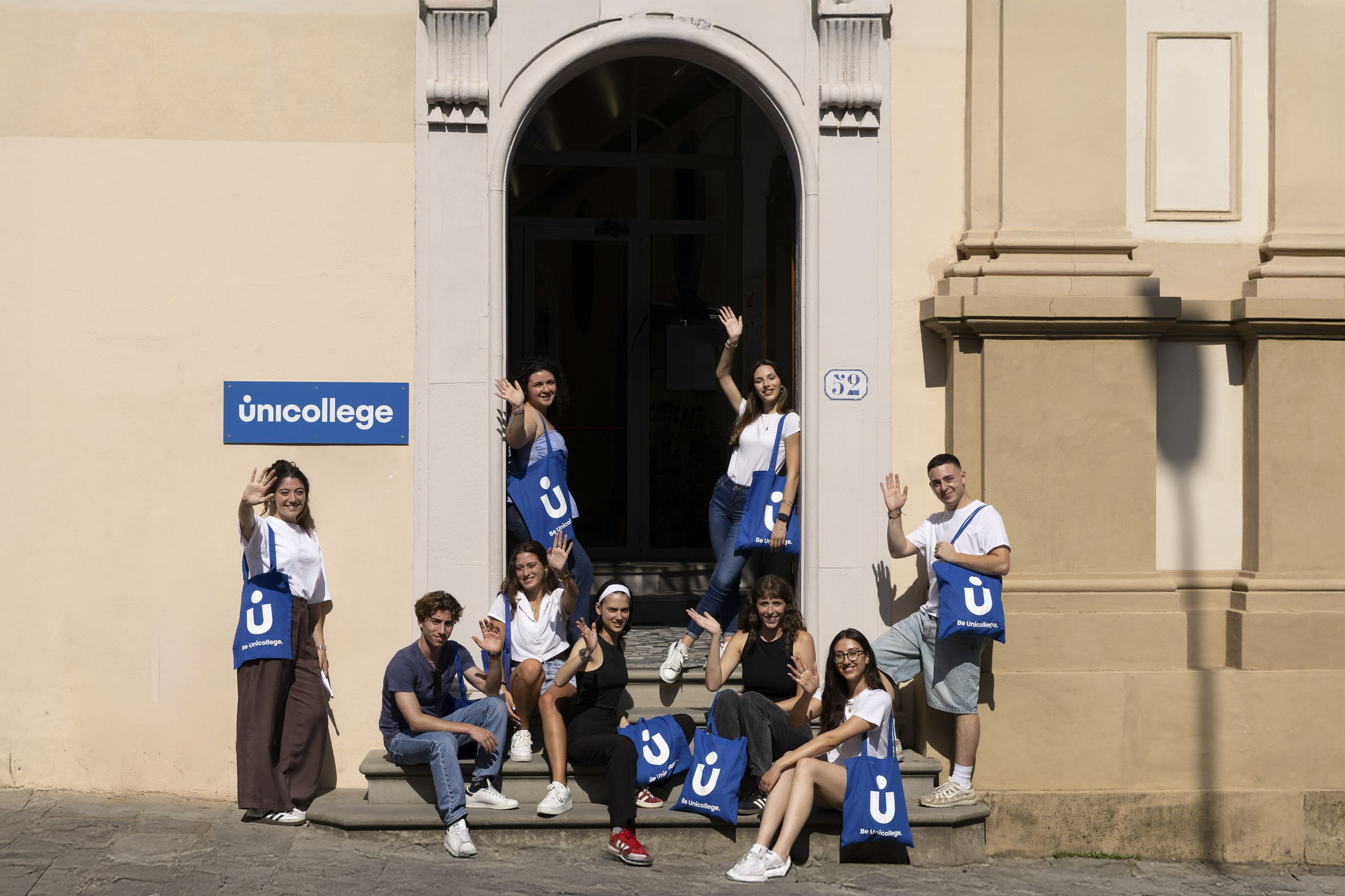 Students with Unicollege tote bags gathered at the campus entrance