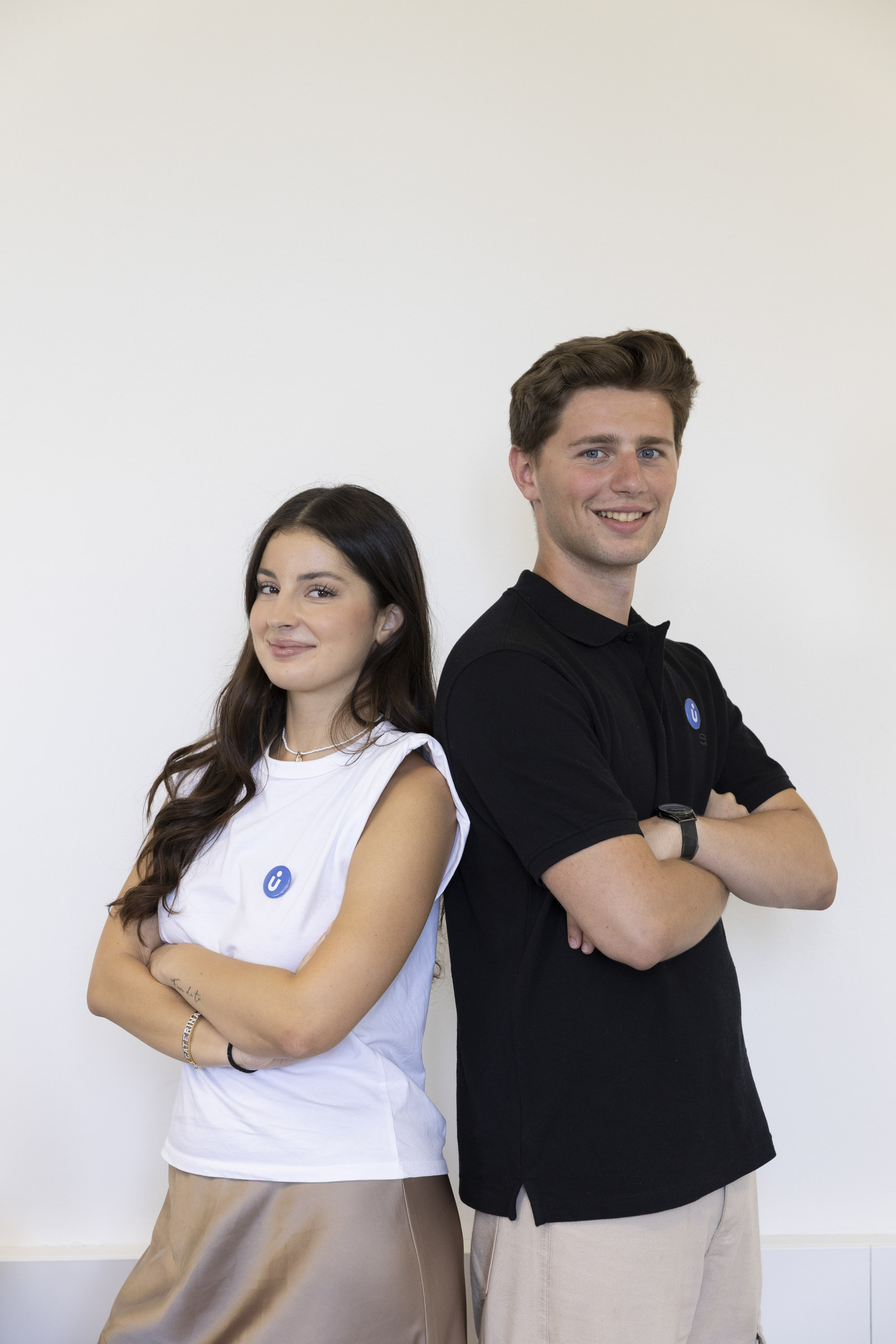 Two students smiling and chatting outdoors on campus